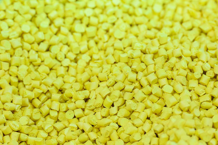 The pile of yellow pellets materials for plastic injection process. The raw material from petrochemical products.の写真素材