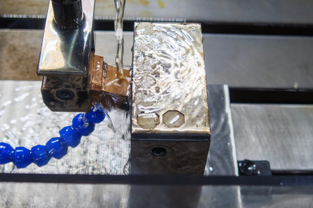 The operation of side spark EDM machine with copper electrode. The mold and die manufacturing...