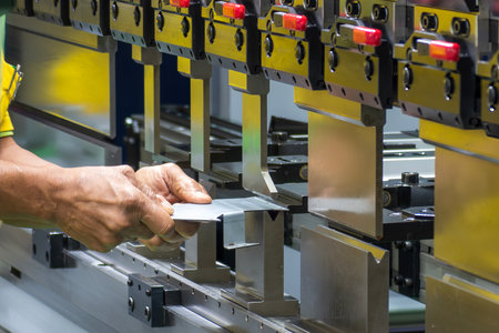 Close up the bending machine operator hold the sheet metal parts. The sheet metal working operation...