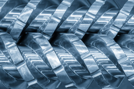 Close up scene body of the barrel screw of injection machine spare parts in the blue tone scene. The...