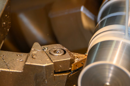 Close up scene the lathe machine finish cut metal shaft parts with liquid coolant method. The...