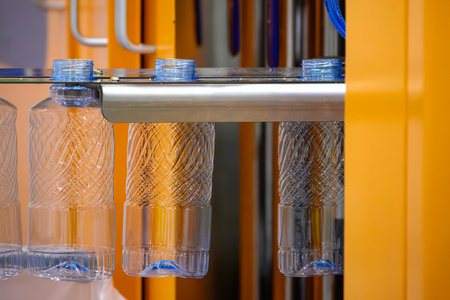 The empty PET bottles mass production by blow mold machine. Close up scene operation of blow mold machine.の写真素材