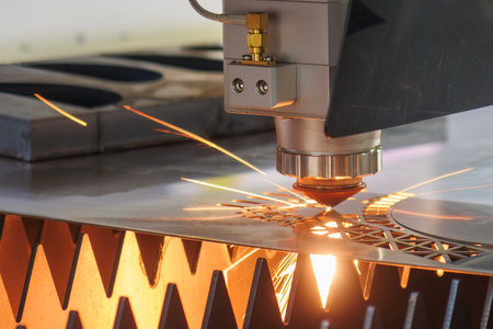 Close up scene the fiber laser cutting machine cut the metal plate control by CNC program. The high technology sheet metal manufacturing process by laser cutting machine.の写真素材