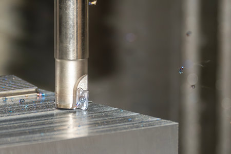 Close up scene the CNC milling machine rough cutting the mold parts by indexable tools. The mold and...