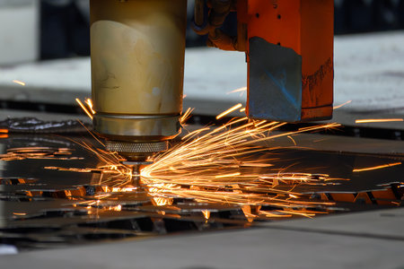 Close up scene the fiber laser cutting machine cut the metal plate control by CNC program. The high...