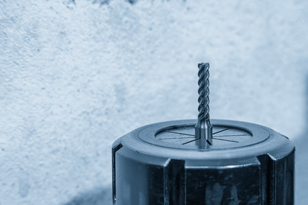 Close-up scene the used flat nose or square shape end mill tools in the blue tone scene. The cutting  tool for machining center.の写真素材