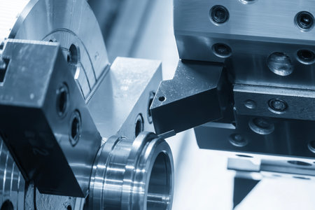 The CNC lathe machine forming cutting the metal tube parts in the light blue scene. The high...