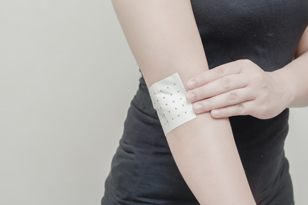 Women Arm muscle pain and sticking plaster.の写真素材