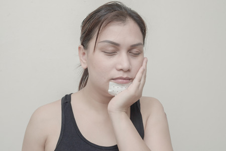 Women Teeth, jaw pain and sticking plaster.の写真素材
