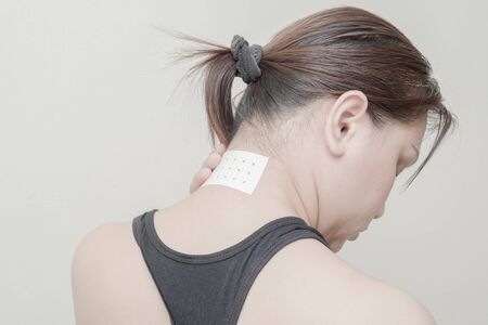 Women Neck, shoulder pain and sticking plaster.の写真素材