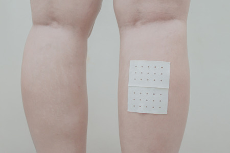 Women leg muscle pain and sticking plaster.の写真素材