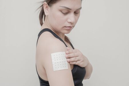 Women Arm muscle pain and sticking plaster.の写真素材