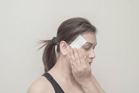 Women headaches and plaster on her head.の写真素材