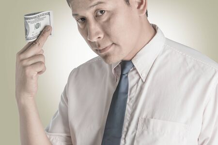 Asian businessmen Happy when he had a dollar.の写真素材