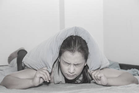 woman head pain in bed black and white picture.Conception of illnessの写真素材