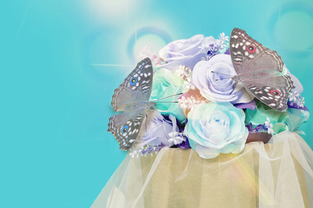 Butterflies and Flowers from beautiful decorative fabric for the backdrop.Light blue tone.の写真素材