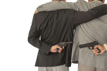 Behind the two businessmen holding a gun,Concepcion dishonesty in business.の写真素材