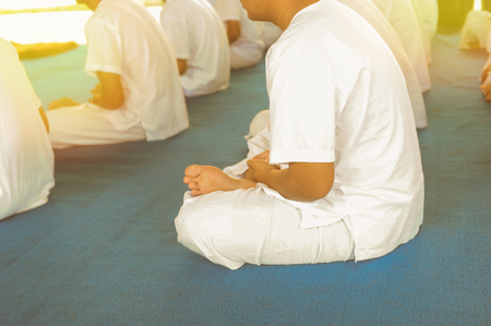Meditate in groups in white on a blue background.Concept of meditation in a Buddhist monastery.の写真素材