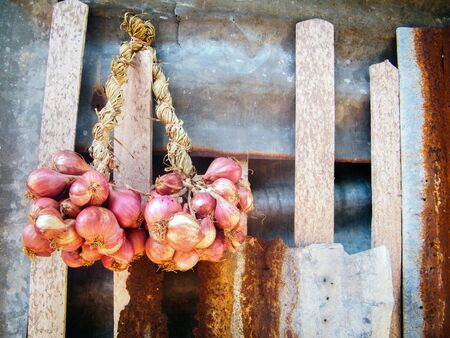Red Onion hanging on the wall of the house.の写真素材