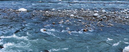 flowing river having rocks in the middleの写真素材