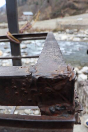 metal rod having flowing river in the backgroundの写真素材