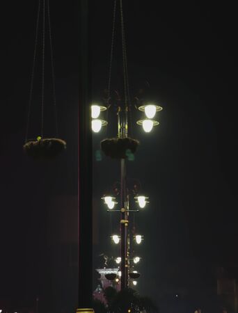 street lamps switched on during night and winter season amritsarの写真素材