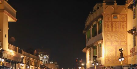 building illuminated with lights on both side of road in amritsar outside golden templeの写真素材
