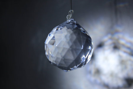 The light shine from the white crystal over black backgroundの写真素材