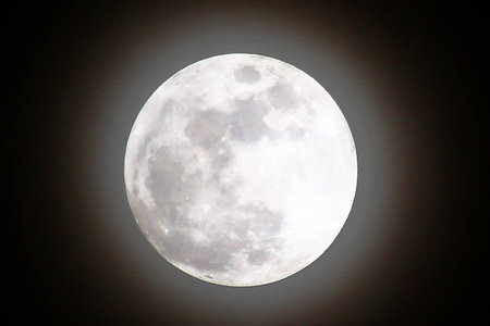 Full moon with radius in the  dark skyの写真素材