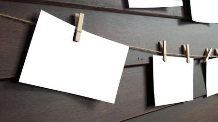 close up of an old photo and clothes peg on a wooden backgroundの写真素材