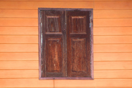 Ancient wood window on wooden wallの写真素材