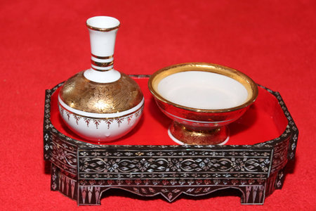 Porcelain pour water ceremonial  in marquetry tray on red backgroundの写真素材