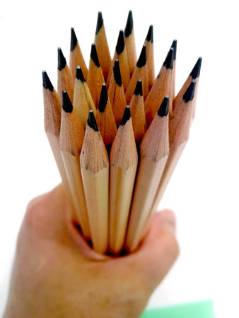 Pencils  in hand  on white  backgroundの写真素材