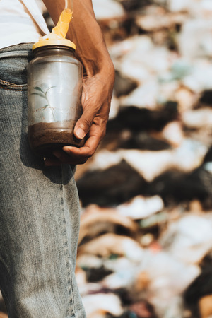 glass bottle in hand with trees growing inside a glass bottle to create oxygen. concept for save the world and environmental disaster and air pollution.の写真素材
