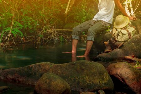 Hiking and resting and and foot bath in brook for relax after tired of hiking  concept forest on background summer journey vacations outdoor in tropical forest of Thailand,Phang nga,koh yao yaiの写真素材