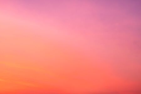 Abstract blur beautiful bright orange and golden sky at sunsetの写真素材