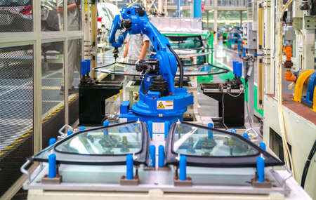Automation concept: View of robot glass sealing in automotive manufacturing plantの写真素材