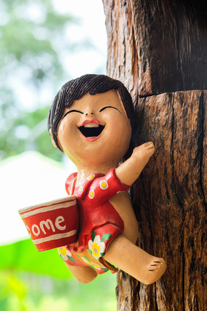 Smily girl doll on the wooden wallの写真素材