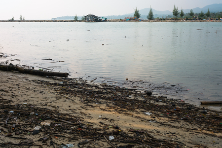 Dirty beach after rain storm and big waveの写真素材