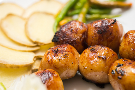 Closeup Thai style Grilled sausages in plate with ginger and chilliの写真素材