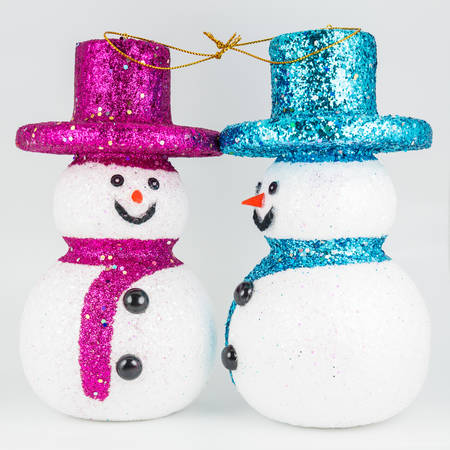 Pink and blue snowmans on white backgroundの写真素材