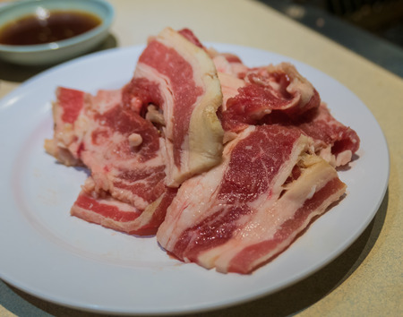 Streaky pork on white plateの写真素材