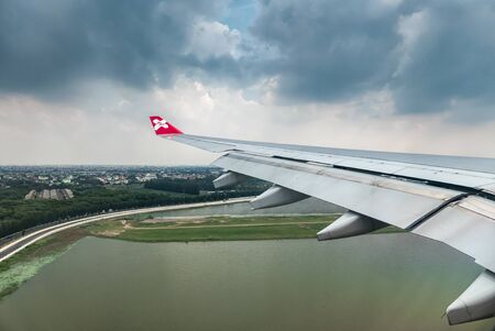Bangkok, Thailand - DECEMBER 5, 2015 Window of Airasia airplane in the afternoon landing at Donmuang airport, Bangkok, Thailandのeditorial素材