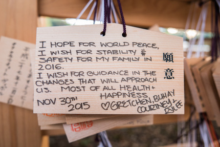 Tokyo, Japan - November 30, 2015: People write their wish on a wooden board (ema) and leave that at the Meiji Shrine, a Shinto complex in Tokyo dedicated to the Emperor Meiji and his wife, Empress ShÅken. Completed in 1926, it is situated in 175 acres ofのeditorial素材