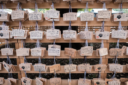 Tokyo, Japan - November 30, 2015: People write their wish on a wooden board (ema) and leave that at the Meiji Shrine, a Shinto complex in Tokyo dedicated to the Emperor Meiji and his wife, Empress ShÅken. Completed in 1926, it is situated in 175 acres ofのeditorial素材