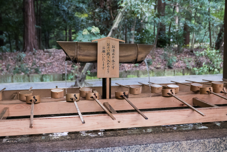 Tokyo, Japan - November 30, 2015: A purification trough by the entrance to the Meiji Shrine in Tokyo. Shinto observers use it to wash their hands and mouths before entering the shrine.のeditorial素材