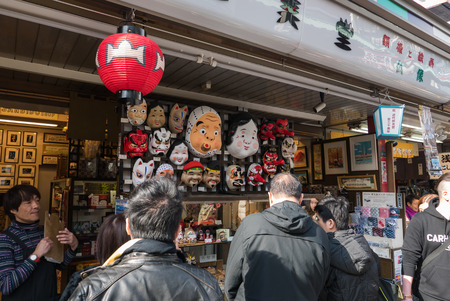 Tokyo, Japan - Nov 30, 2015: Crowds of visitors browsing the colourful market stalls of Nakamise-dori the popular destination leading to Senso-ji temple in the Asakusa district of downtown Tokyo, Japan./ Crowds of visitors browsing the colourful market stのeditorial素材