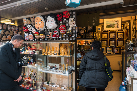 Tokyo, Japan - Nov 30, 2015: Crowds of visitors browsing the colourful market stalls of Nakamise-dori the popular destination leading to Senso-ji temple in the Asakusa district of downtown Tokyo, Japan./ Crowds of visitors browsing the colourful market stのeditorial素材