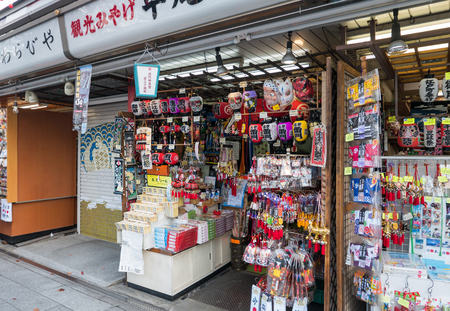 Tokyo, Japan - Nov 30, 2015: Crowds of visitors browsing the colourful market stalls of Nakamise-dori the popular destination leading to Senso-ji temple in the Asakusa district of downtown Tokyo, Japan./ Crowds of visitors browsing the colourful market stのeditorial素材