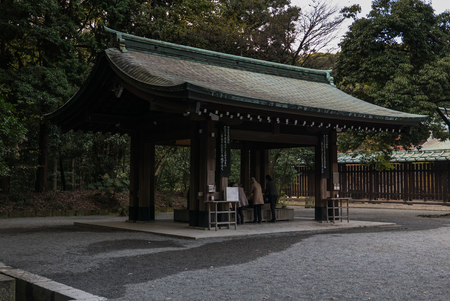 Tokyo, Japan - November 30, 2015: Several tourists visiting the centre of a famous shrine in Tokyo, Japan.のeditorial素材